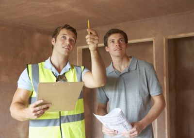 Builder And Inspector Looking At New Property